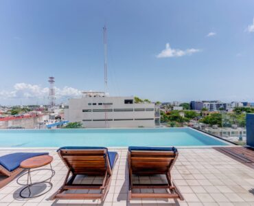 two bedroom condo riva playa del carmen sunbeds in pool