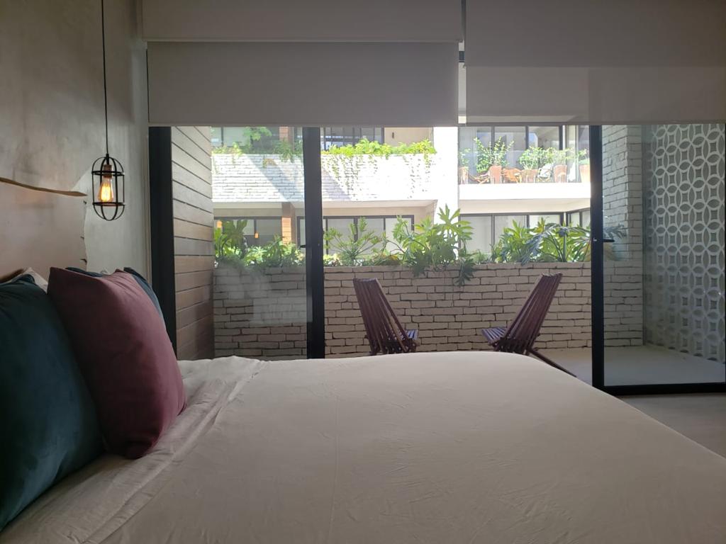 e tulum condos for sale sanctuary master bed balcony