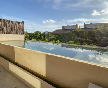 o essentia condos for sale aldea zama rooftop bedroom pool green view