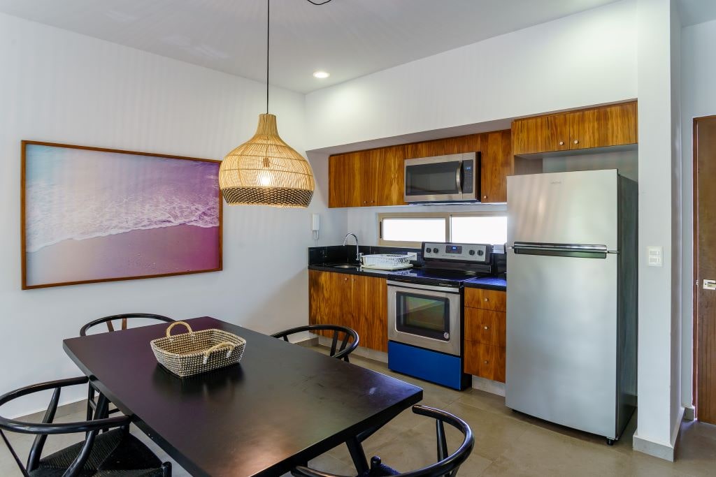c tulum real estate puerta zama terra condo dining area and kitchen