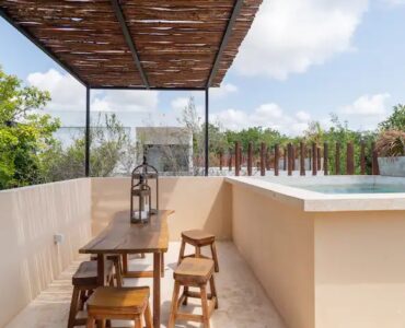 four bedroom condo for sale in tulum mun rooftop pool with table