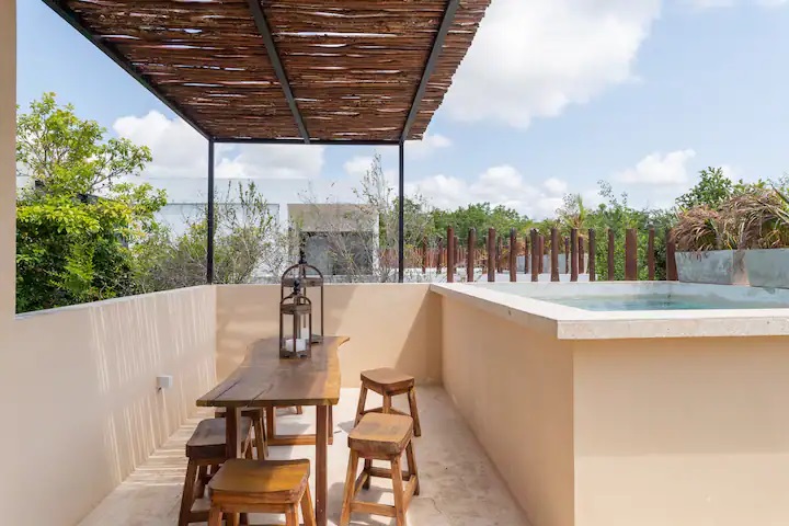 four bedroom condo for sale in tulum mun rooftop pool with table